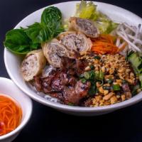 Combo Eggroll Bbq Pork Vermicelli · The salad bowl is served with marinated grilled pork, egg rolls, vermicelli rice noodles, sc...