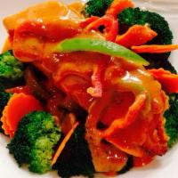 Panang Curry Salmon · Red curry reduced with peanut sauce, broccoli, cabbage, carrots, topped with Salmon.