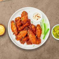 Mild Mild Wings · Fresh chicken wings fried until golden brown, and tossed in mild buffalo sauce. Served with ...