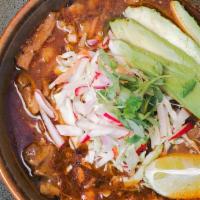 Pozole · Red chilli-spiced Mexican soup with pork, hominy, cilantro, avocado, radish, red onions, cab...
