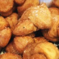 Garlic Knots · Deep fried mini doughballs, coated in butter and garlic oil, served with a side of marinara.