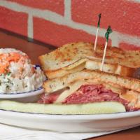 Ny Reuben · Corned beef or pastrami with swiss cheese, a pile of sauerkraut and Russian dressing served ...