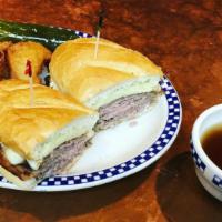 French Dip · Tender shaved beef grilled and topped with swiss cheese. Served with au jus.