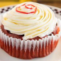 Scarlet Red Velvet Chocolate Chip Jumbo Cupcake · With cream cheese icing.