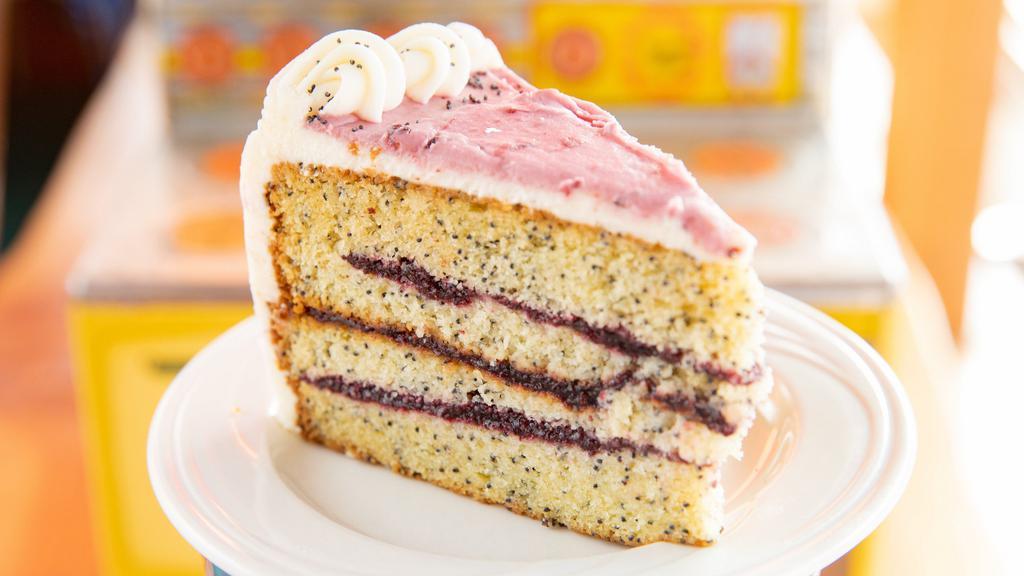 Marionberry Poppyseed Cake Slice · Poppyseed cake filled with Oregon marionberry filling and cream cheese icing.
