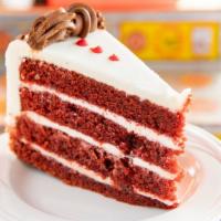 Scarlet Red Velvet Chip Cake Slice · A classic red velvet cake with chocolate chips and rich cream cheese icing.