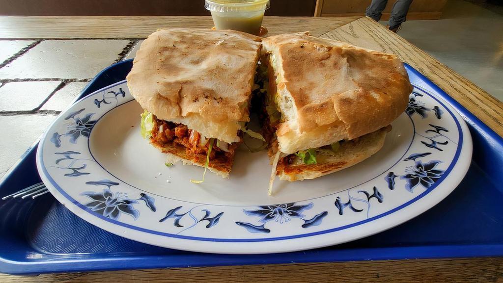 Torta · Our special Mexican sandwich made with beans, your choice of meat, lettuce, tomatoes, guacamole, and onion.