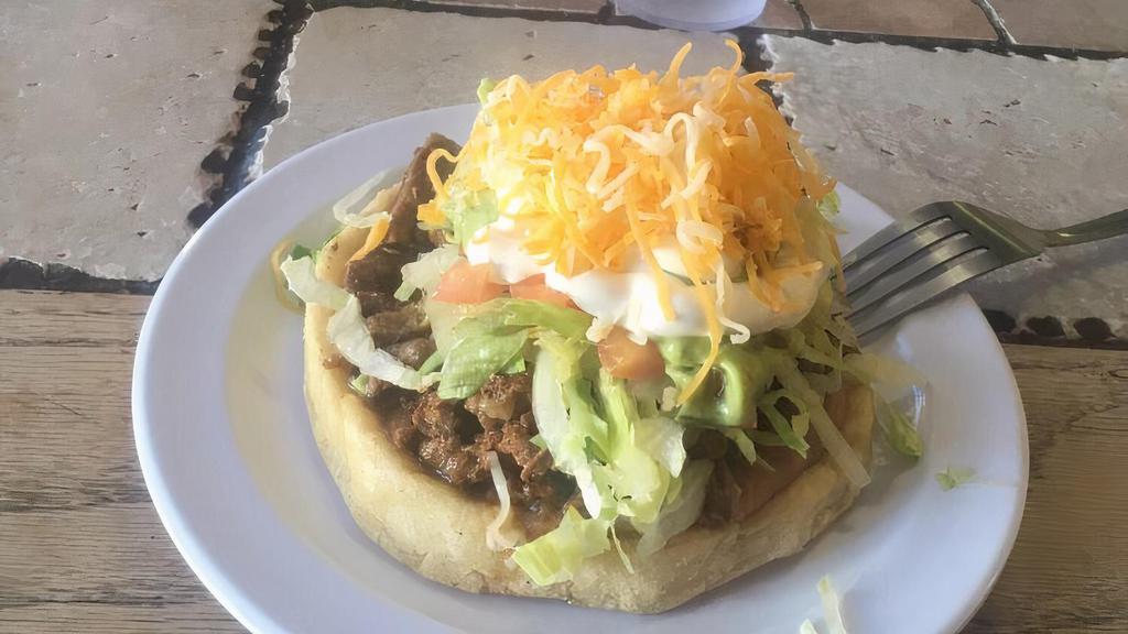 Sopes · Handmade masa patties topped with beans, your choice of meat, lettuce, tomatoes, sour cream, guacamole, and cheese.