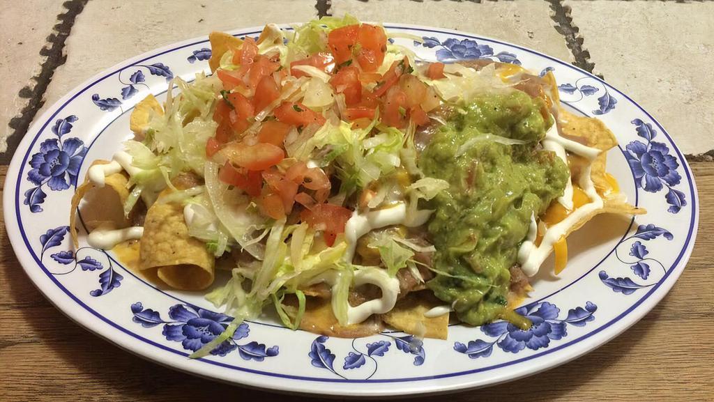 Super Nachos · Corn tortilla chips topped with refried beans, your choice of meat, cheese, sour cream, guacamole, and pico.
