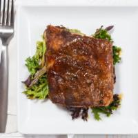 Baby Back Ribs · Asian spice-rubbed pork ribs with a bourbon pineapple sauce.