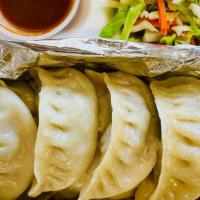 Steamed Beef Momo · Filled with ground beef, cabbage, yellow onions, cilantro, garlic, Soysauce, Salt. Served wi...