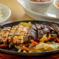 Fajitas · Sliced meat sautÃ©ed with green peppers and onions. Served with guacamole, sour cream, and p...