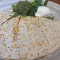 Quesadilla · Warm grilled flour tortilla filled with queso fresco and your choice of chicken or beef. Gar...