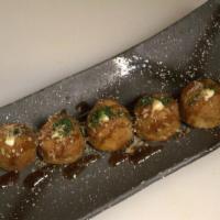 Takoyaki · Japanese appetizer filled with diced octopus.