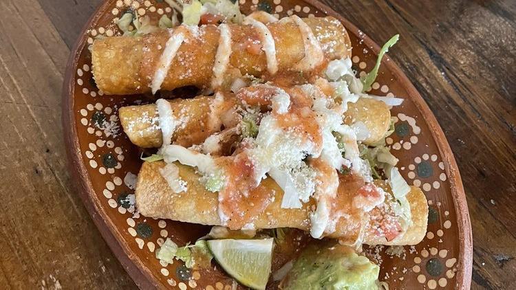 Flautas · Three fried crispy corn tortillas rolled around shredded chicken. Topped with lettuce, mild red sauce, guacamole, sour cream drizzle & Cotija Cheese