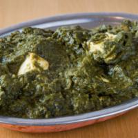 Saag Paneer · Indian cottage cheese cubes cooked in smooth and creamy spinach gravy.
