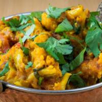 Aloo Gobi · Potatoes and cauliflower cooked with herbs and spices.