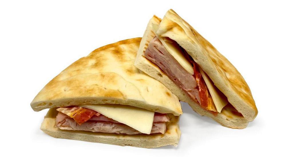 Sandwiches & Wraps|Turkey & Ham Flatbread Club Sandwich · A flatbread club sandwich with turkey, ham, bacon, lettuce, & American cheese. Mayo and mustard packet on the side. 370 Calories