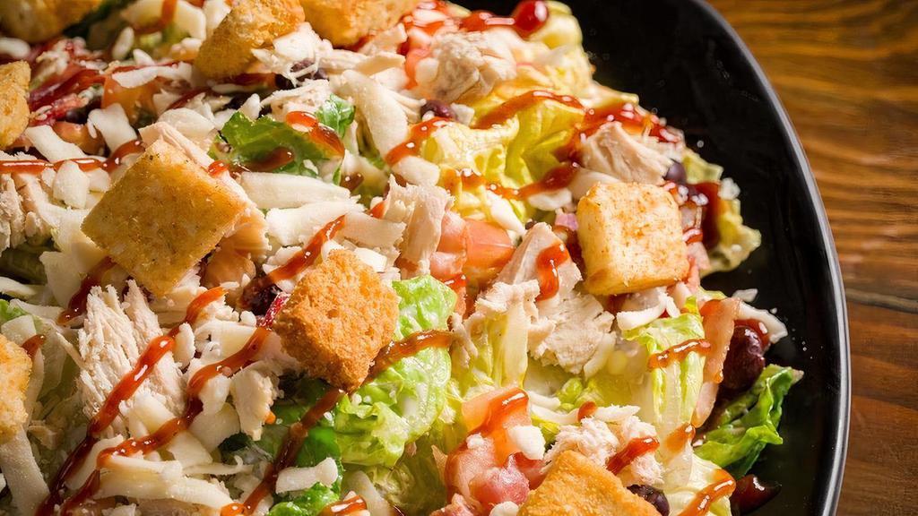 Bbq Chicken Chop Salad · Grilled chicken, bacon, romaine lettuce, Mozzarella cheese, diced tomatoes, black beans, tossed in peppercorn ranch dressing, drizzled with BBQ sauce, garlic croutons