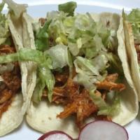 Red Mole Chicken Taco · Shredded chicken and onions cooked on a red mole sauce, lettuce.