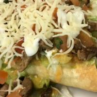 Flautas Supreme (5) · Five shredded beef flautas (rolled tacos) topped with cheese, carne asada, pico de gallo, le...