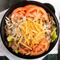 The Everything Steak Salad · Steak, mushrooms, green peppers, onions, tomatoes and Mozzarella cheese on a bed of lettuce.
