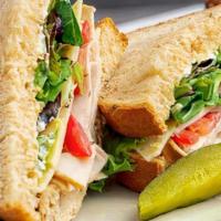 Turkey Deli Sandwich · Roasted turkey, mayo, baby greens, fresh tomatoes, and swiss cheese served cold on wheat bre...