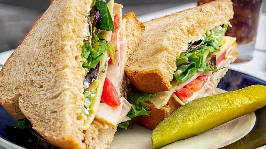 Turkey Deli Sandwich · Roasted turkey, mayo, baby greens, fresh tomatoes, and swiss cheese served cold on wheat bread.