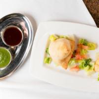 Vegetable Samosa · Vegan. Deep fried pastries filled with mildly spiced potatoes and peas.