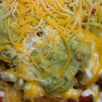 Super Nachos · Fried corn tortilla chips with refried beans, cheese, picode gallo salsa, sour cream and cho...