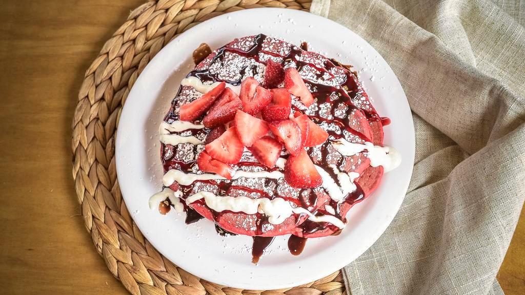 The Lover · Red velvet griddle cakes, strawberries, whipped cream and a raspberry and chocolate drizzle.