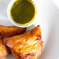 Vegetable Samosa · 2 crisp pastries stuffed with potatoes and green peas. Served with hot and mild chutneys.