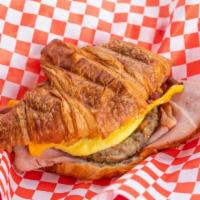 Breakfast Croissant · A toasted croissant served with ham, sausage, bacon, egg and cheese.