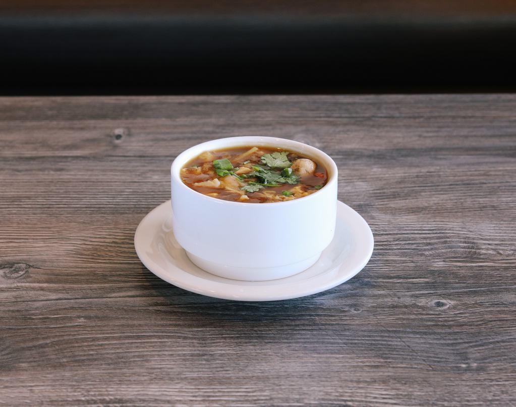 Hot & Sour Soup · Spicy. Rich and tangy broth with chicken, shrimp, mushrooms, cilantro, and green onions.