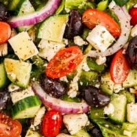 Greek Salad · A mix of lettuce, tomato, onion, carrot, purple cabbage, tabouli and feta cheese, tzatziki a...