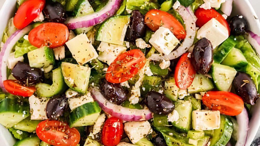 Greek Salad · A mix of lettuce, tomato, onion, carrot, purple cabbage, tabouli and feta cheese, tzatziki and hummus on the side with grape leaves.