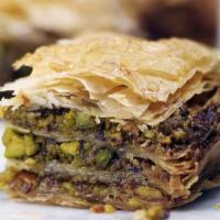 Baklavah (1 Piece) · Home-made sweet flaky crust with pistachio crumbles.
