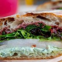 Turkey Boursin Sandwich · Turkey, Boursin cheese, cherry preserves, roasted garlic, greens, and olive oil. Served with...