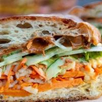 Massaman Curry Banh Mi Sandwich · Roasted yams, spicy peanut butter, cucumber, jalapeno, pickled carrot, daikon radish, and sp...