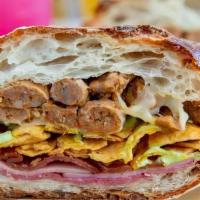 Peruvian Sandwich · Genoa salami, ham, applewood bacon, sausage crumbles, Monterrey Jack, Peruvian sauce, and fr...