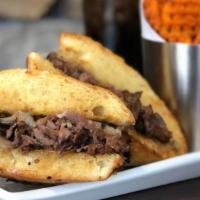 Prime Rib Sandwich · In-house roasted prime rib with Provolone cheese, sauteed onions and mushrooms, on a ciabatt...