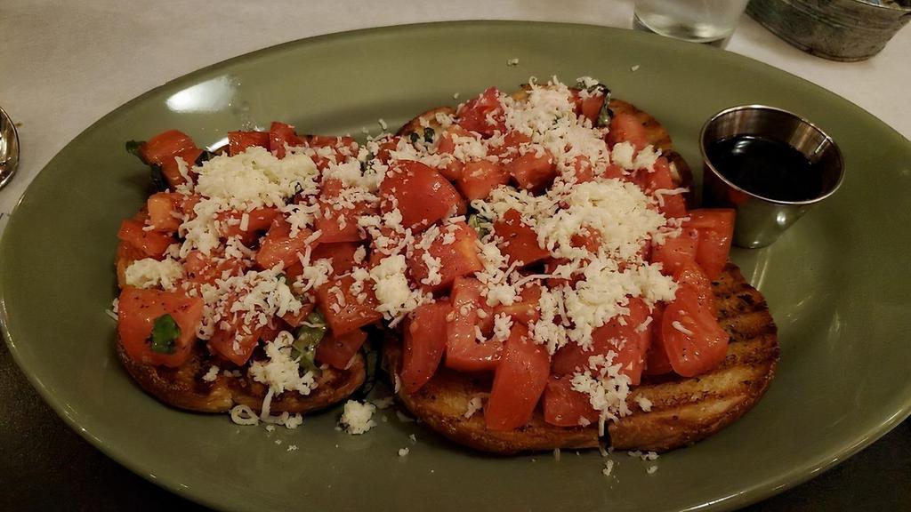Roma Bruschetta · Vine-ripened Roma tomatoes, garlic, mozzarella, and fresh basil, served on panini bread and drizzled with olive oil and balsamic vinegar.