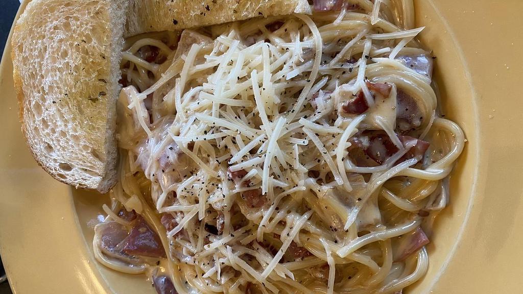Spaghetti Carbonara · Our creamy parmesan sauce with Proscuitto, onion and cracked black pepper.