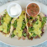 Carnitas (3) · Pork or ground beef served with cilantro, chopped onions and salsa Verde.