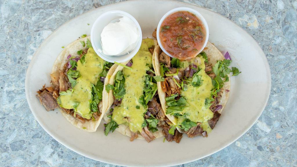 Carnitas (3) · Pork or ground beef served with cilantro, chopped onions and salsa Verde.