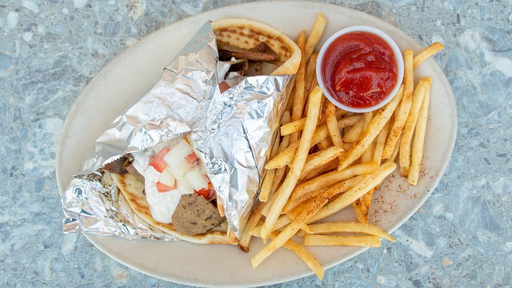 Traditional Gyro · Gyro meat, tomatoes, onions, and tzatziki sauce in a pita.