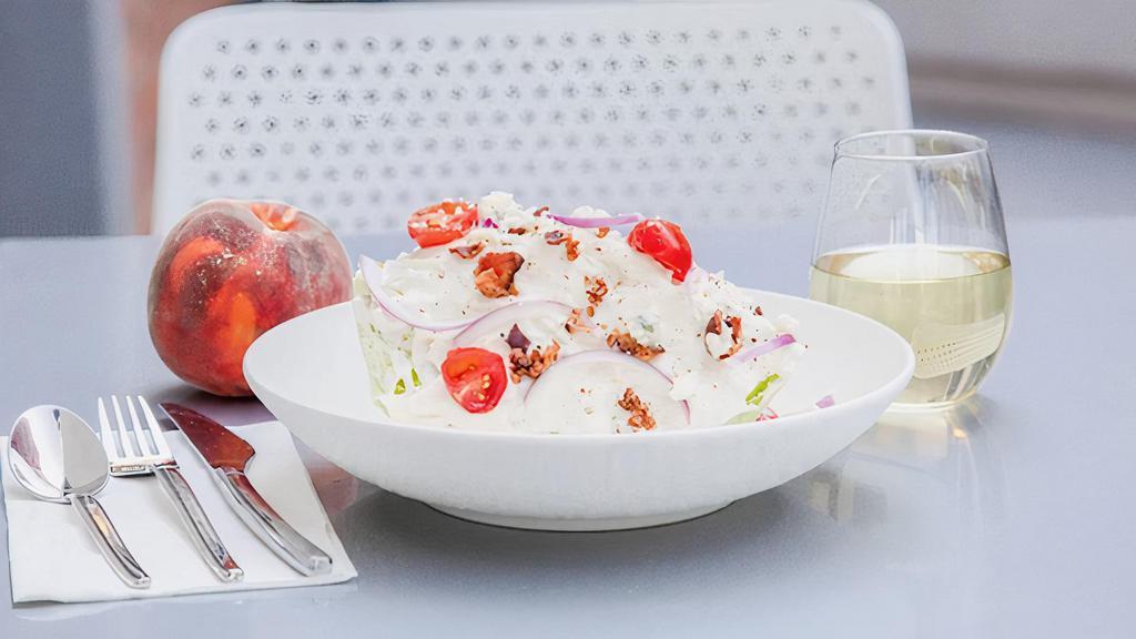 Wedge Salad · iceberg, cherry tomato, red onion, bacon, blue cheese, creamy parmesan dressing