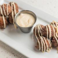 Fresh Fried Donut Holes · Warm donut holes, coated in sugar, and cinnamon with home-made skrewball peanut butter whisk...