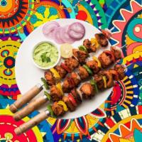 Char Grilled Chicken Tikka · Succulent morsels of chicken, marinated in tandoori masala and yogurt, cooked in an Indian c...