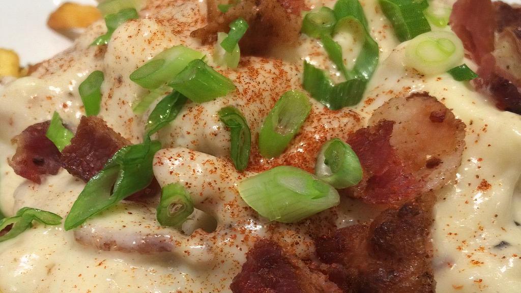 Two Doors Poutine · Fries, southern-style white gravy, Wisconsin cheese curds, crumbled bacon, green onion.